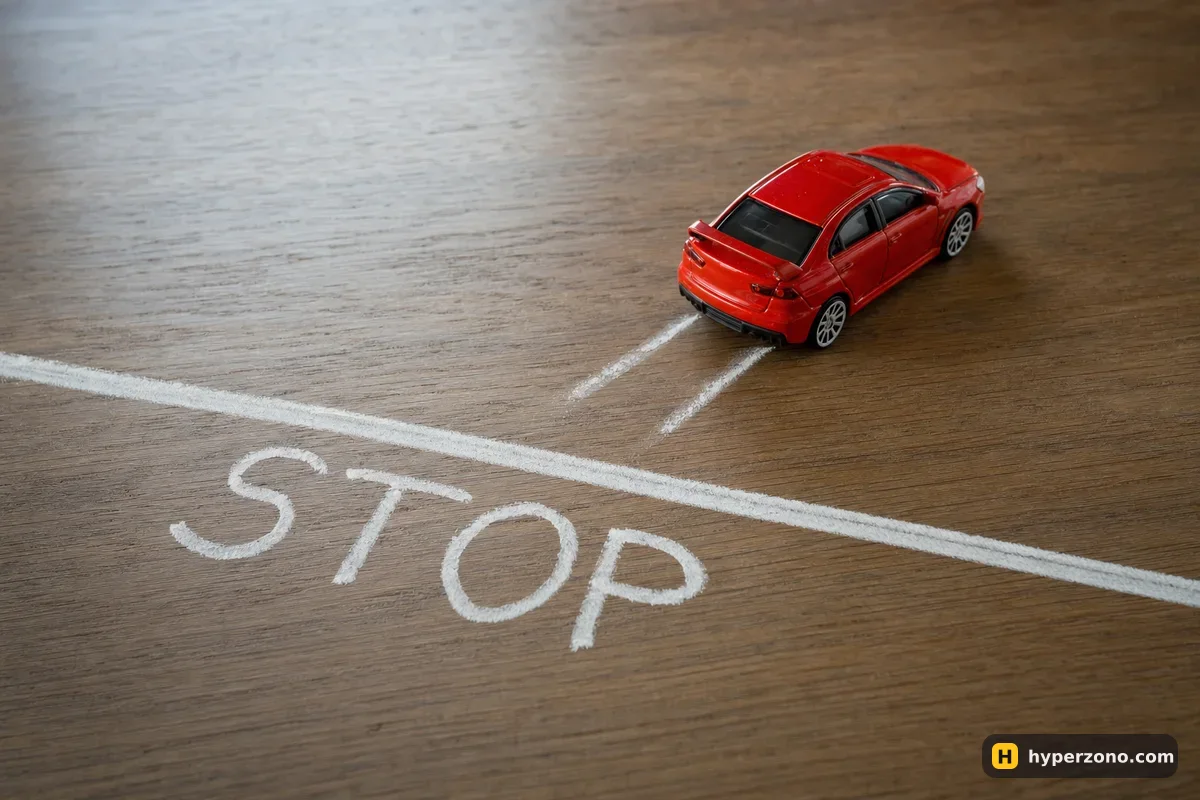 A toy car stopped slightly past a chalk line marked STOP, with skid marks behind it